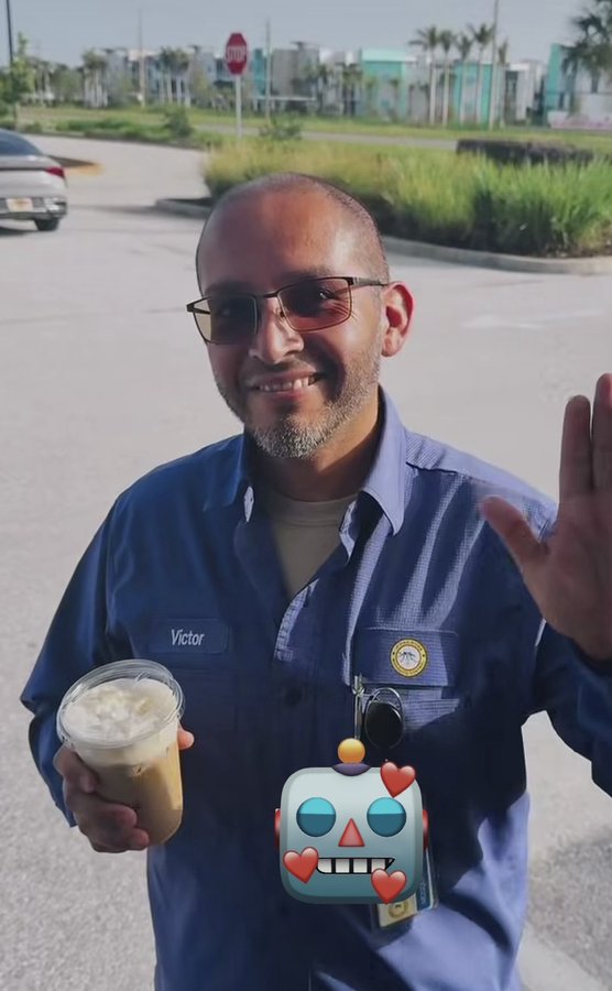 Double H Coffee Co. customer holding an iced coffee, smiling at the trailer window