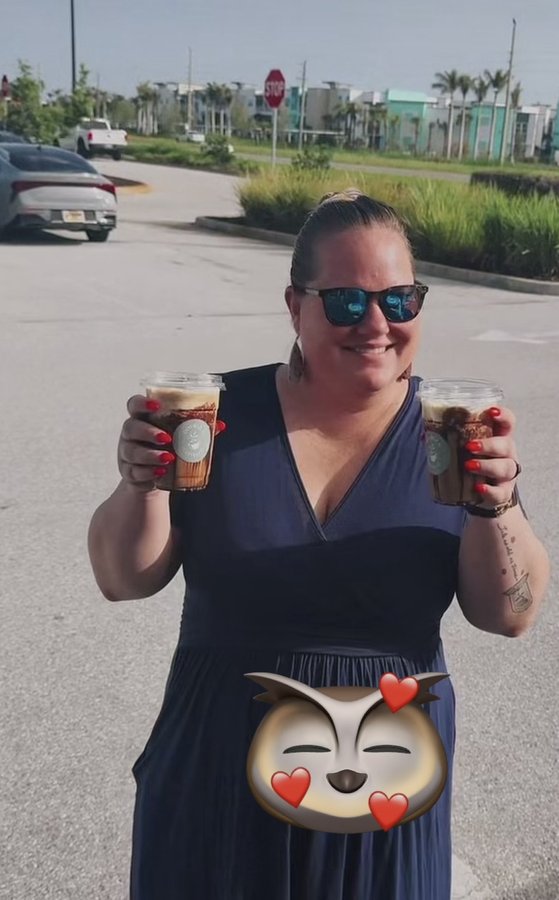 Customer smiling with a Double H Coffee Co. iced coffee