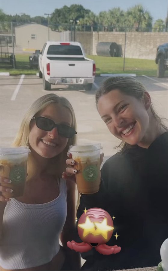 Two customers posing together with Double H Coffee Co. iced coffees